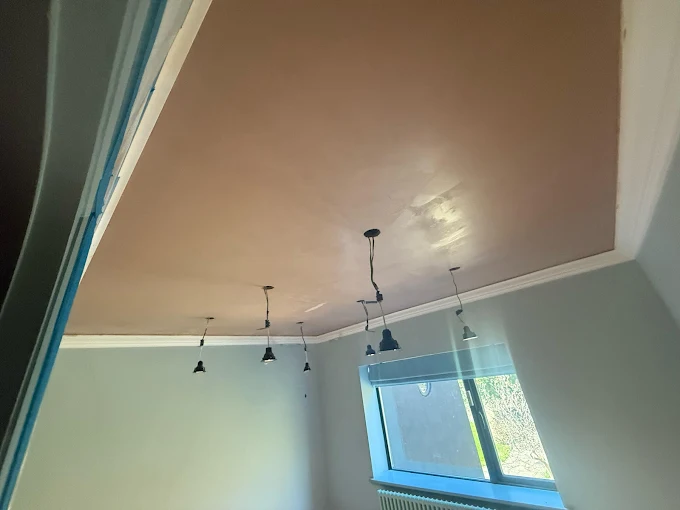 Fresh pink plaster ceiling skim by Home Hues, drying with pendant lights reinstalled