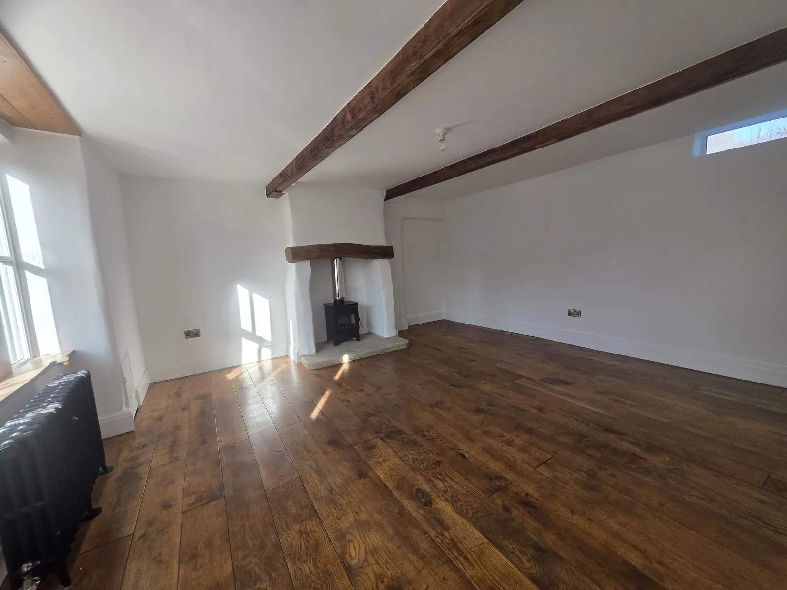 Cottage living room replastered and decorated, original beams cleaned up and left exposed